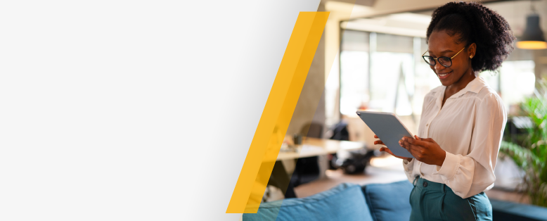 Smiling businesswoman in glasses reads about SAP Cloud ERP myths being busted on a tablet